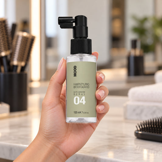 MOOD 04 Shield and Shine Spray 100ml held upright at a salon workstation