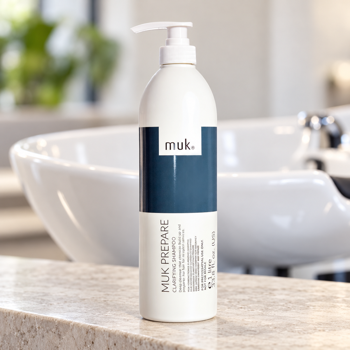 muk Prepare Clarifying Shampoo 1L pump bottle beside a salon wash basin.