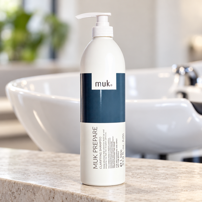 muk Prepare Clarifying Shampoo 1L pump bottle beside a salon wash basin.