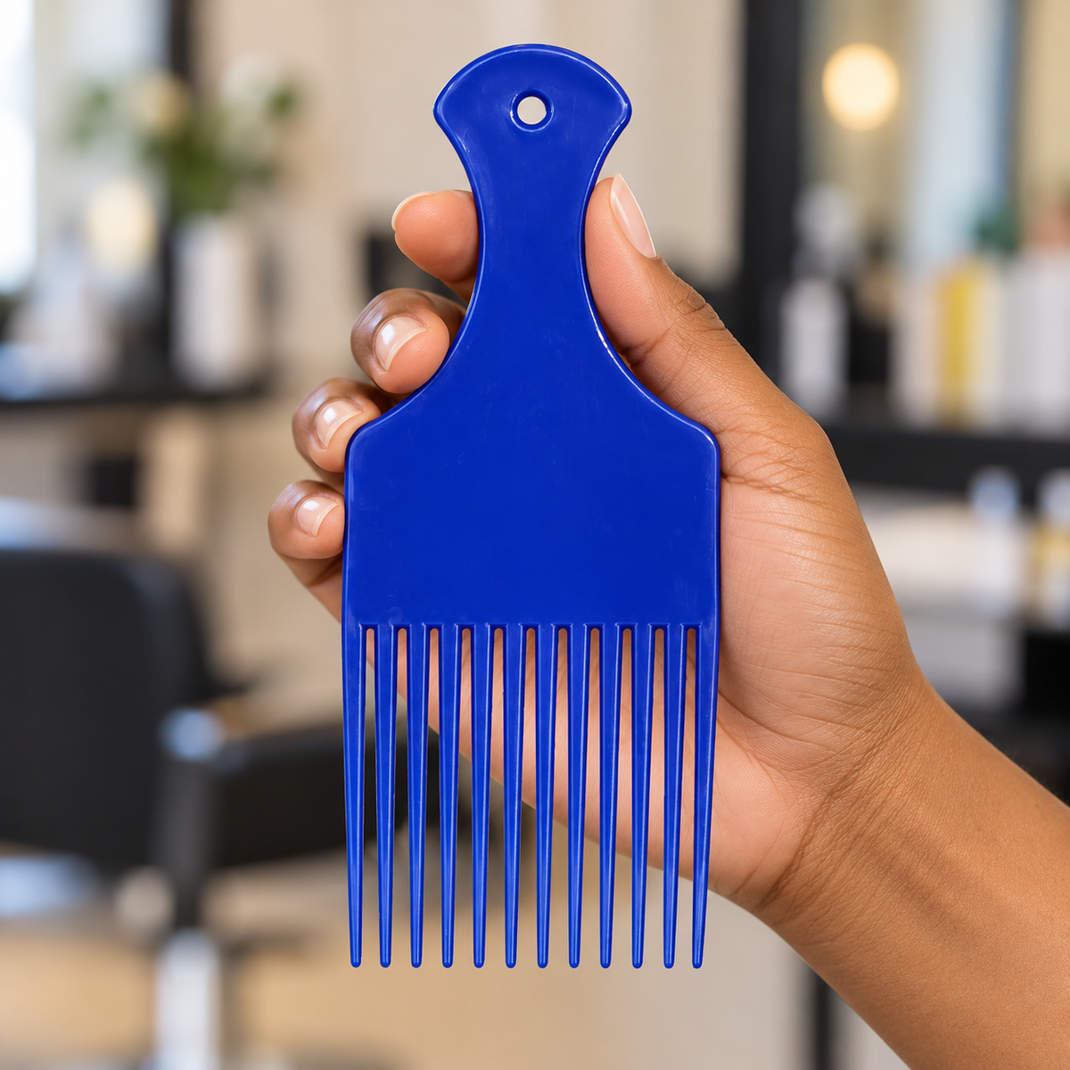 Single blue MV wide-tooth afro pick held by its handle, showing twelve teeth and the hanging hole