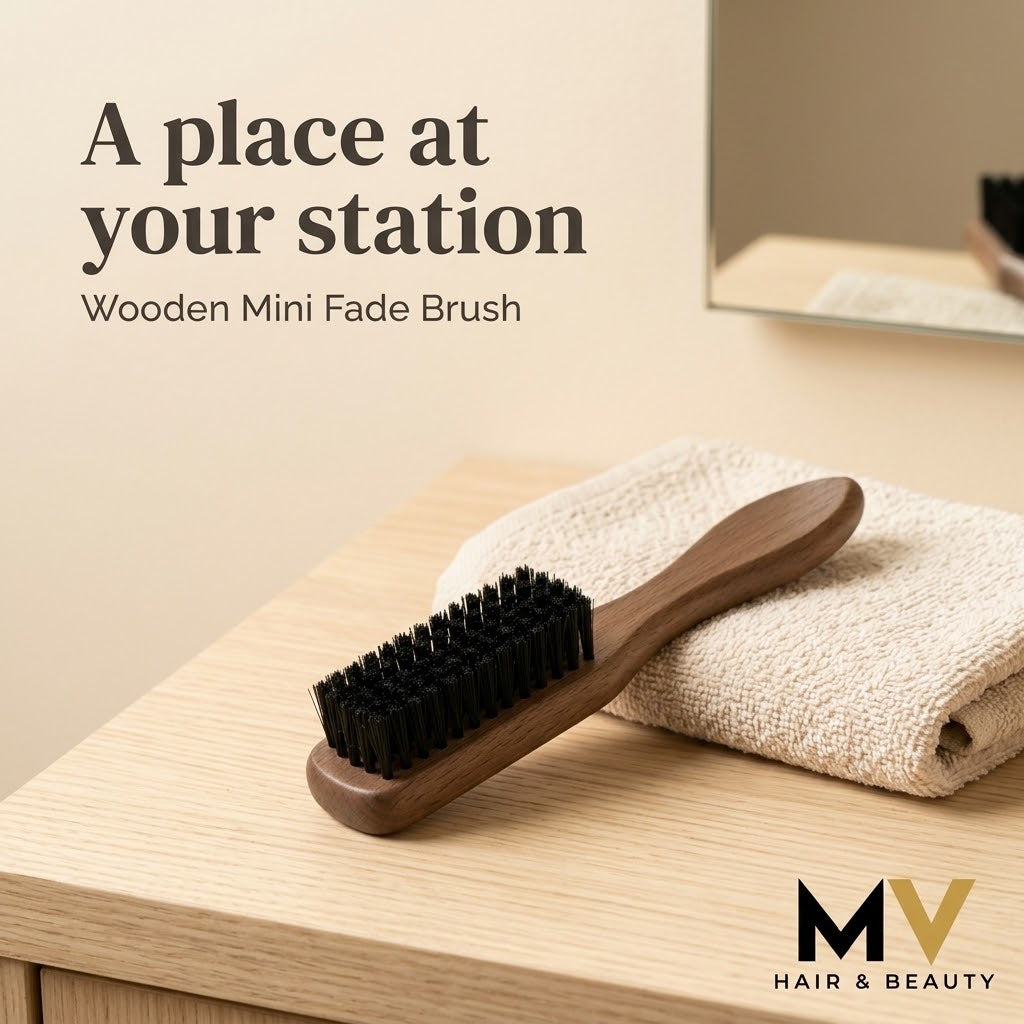 Wooden mini fade brush beside a folded towel on a pale wood barbershop counter, with A place at your station caption and small blended MV logo. AI-created lifestyle presentation.