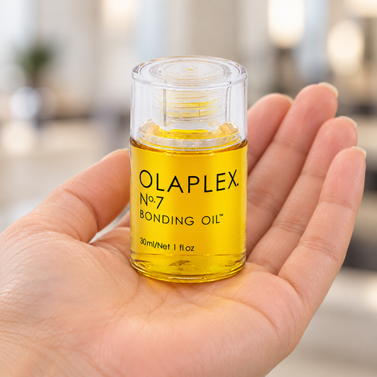 OLAPLEX No.7 Bonding Oil 30ml bottle held upright with the clear cap on.