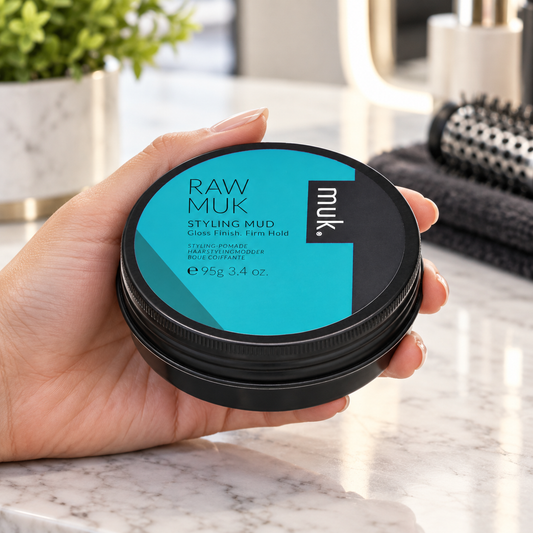 Raw muk Styling Mud 95g shown being handled at a salon station.