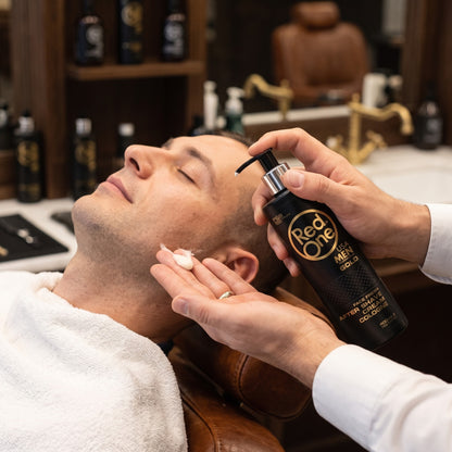 Barber applying RedOne after-shave cream cologne to a client