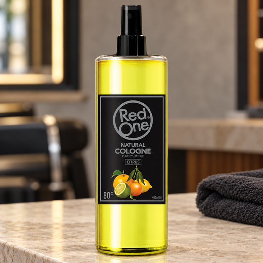 RedOne Citrus natural cologne 400ml spray bottle on a salon counter beside a charcoal towel