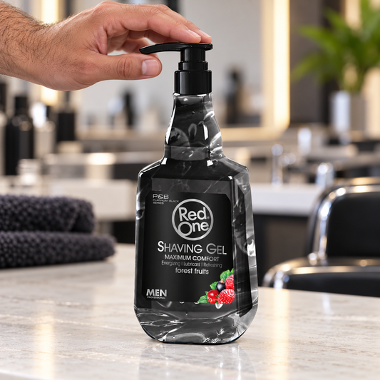 RedOne Fruits Shaving Gel 1000ml tall bottle with a hand resting on its pump at a barber station.