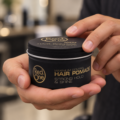 RedOne Creative Hair Pomade 100ml closed tin held in hands, showing the screw lid and printed front.
