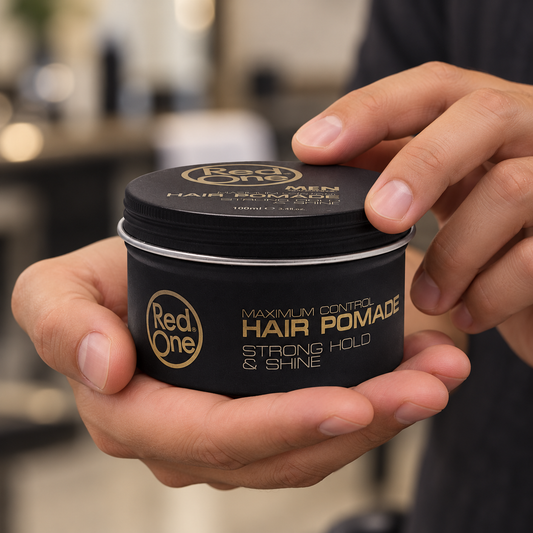 RedOne Creative Hair Pomade 100ml closed tin held in hands, showing the screw lid and printed front.