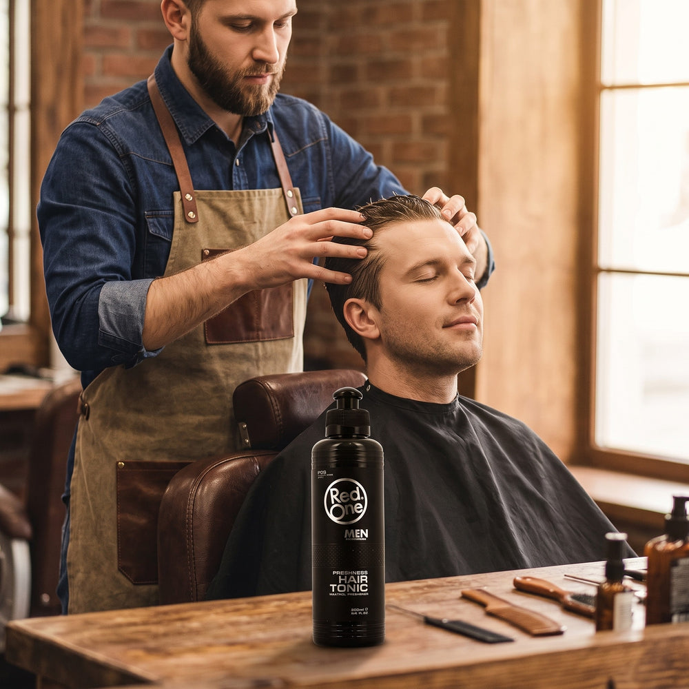 Barber massaging RedOne Hair Tonic into a client's scalp