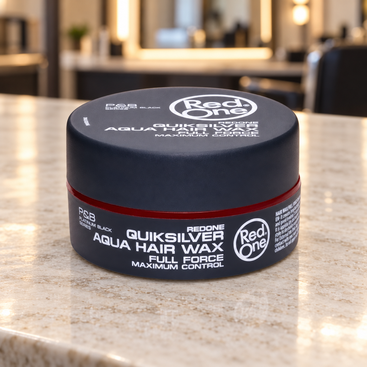 RedOne Quiksilver Aqua Hair Wax Full Force 150ml closed jar on a light barber counter.