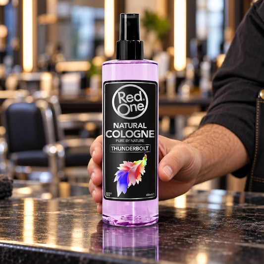 Barber holding RedOne Thunderbolt Natural Cologne 400ml at a salon station