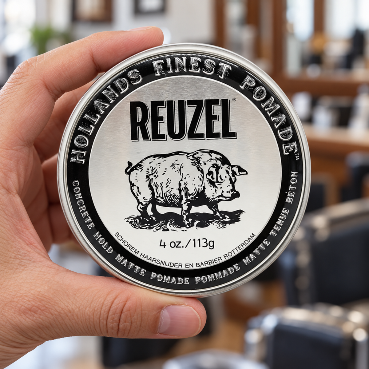 Reuzel Concrete Hold Matte Pomade 113g tin held with its closed lid facing the camera.