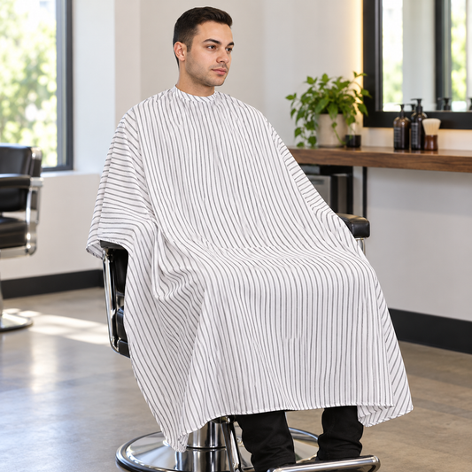 Salon Smart Big Daddy Smooth white pinstriped cape covering a seated salon client